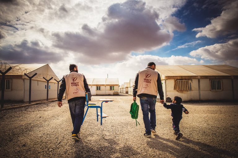 Two adults walking with small child