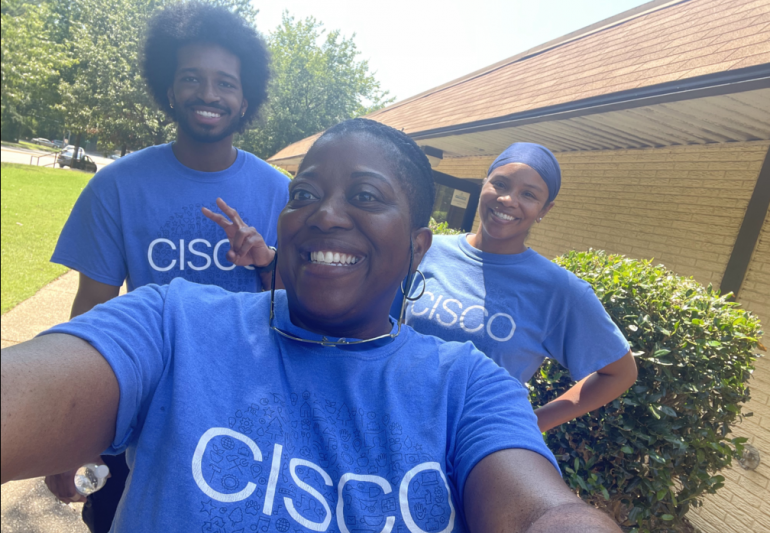 Three people wearing Cisco t-shirts.