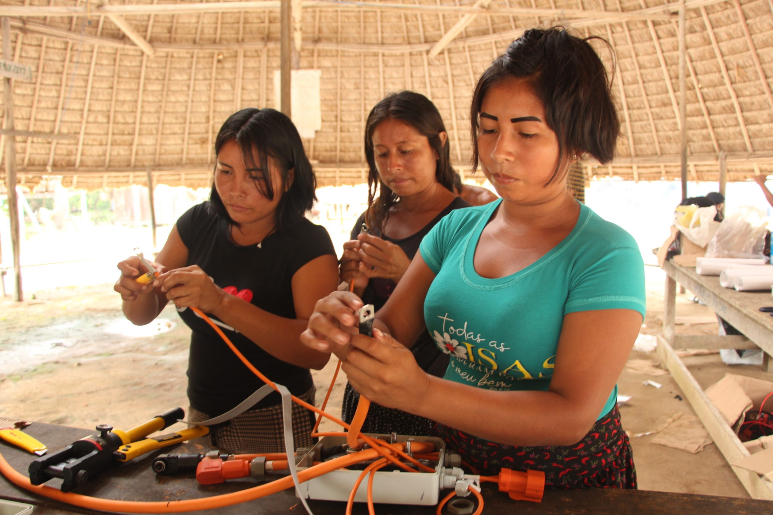 Three women working on a project together
