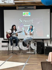 Two people singing on stage.