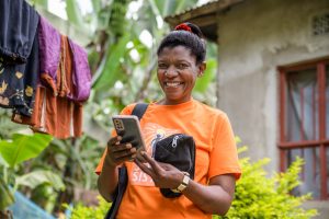 A Solar Sister participant checks out digital tools on their mobile phone