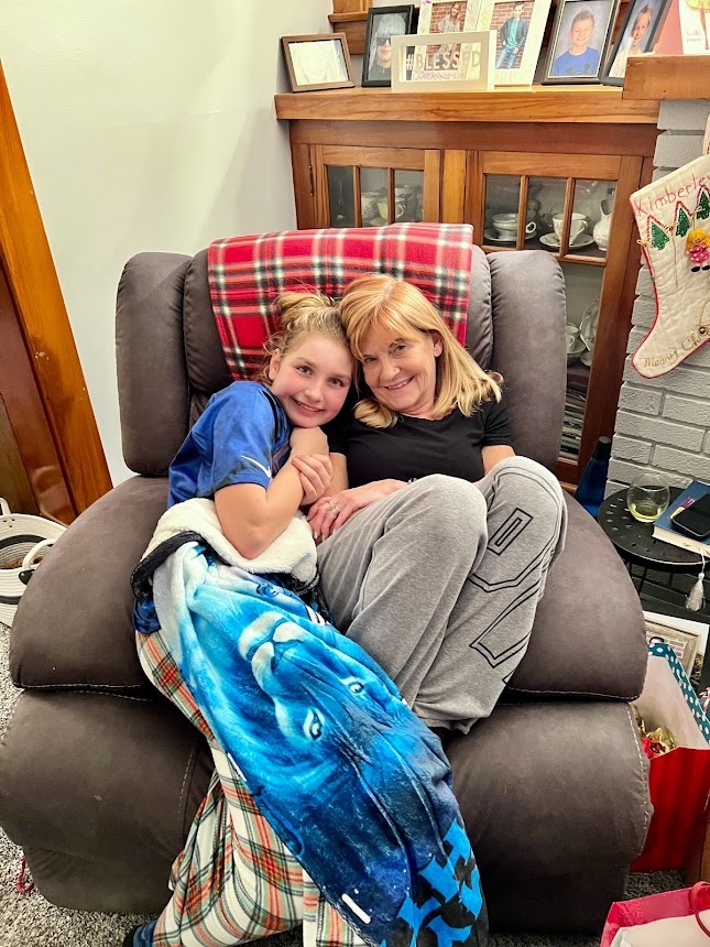 Wendy's daughter and mom on a recliner chair.