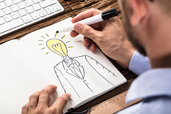 An entrepeneur drawing a light bulb