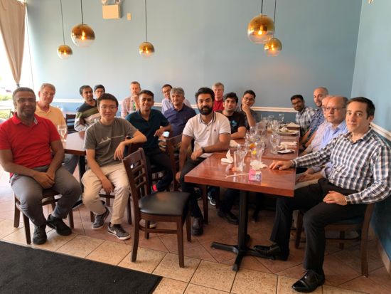 Dhwan sitting with a group of coworkers after a meal.