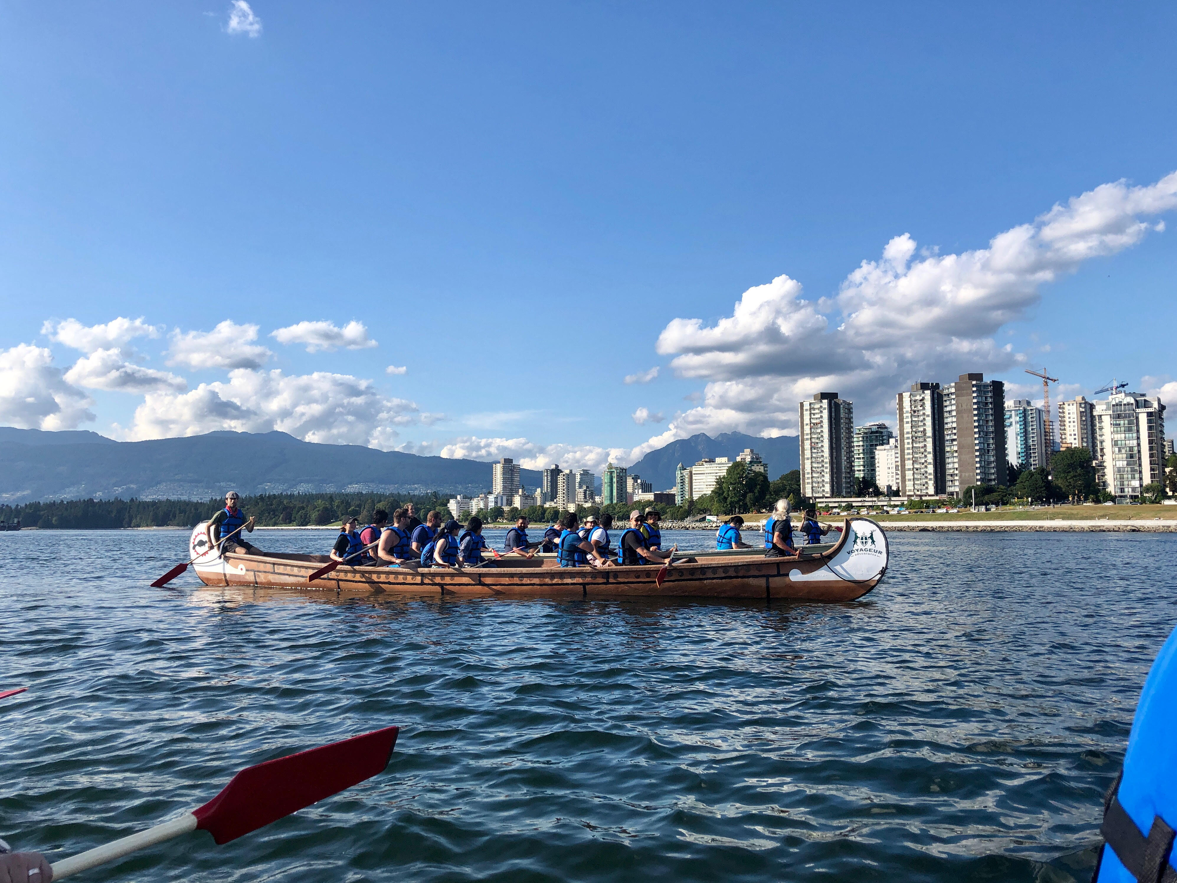 Sang's peers in a kayak overlooking Vancouver.
