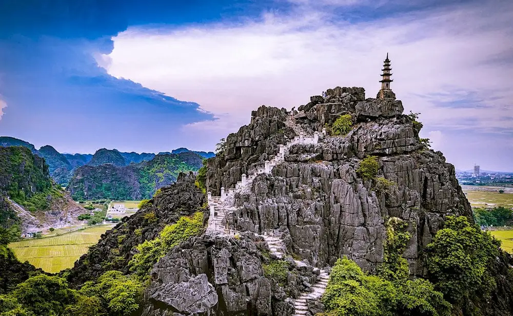 Breathtaking 360-degree view from the top of Mua Cave over the Ninh Binh countryside and limestone mountains.