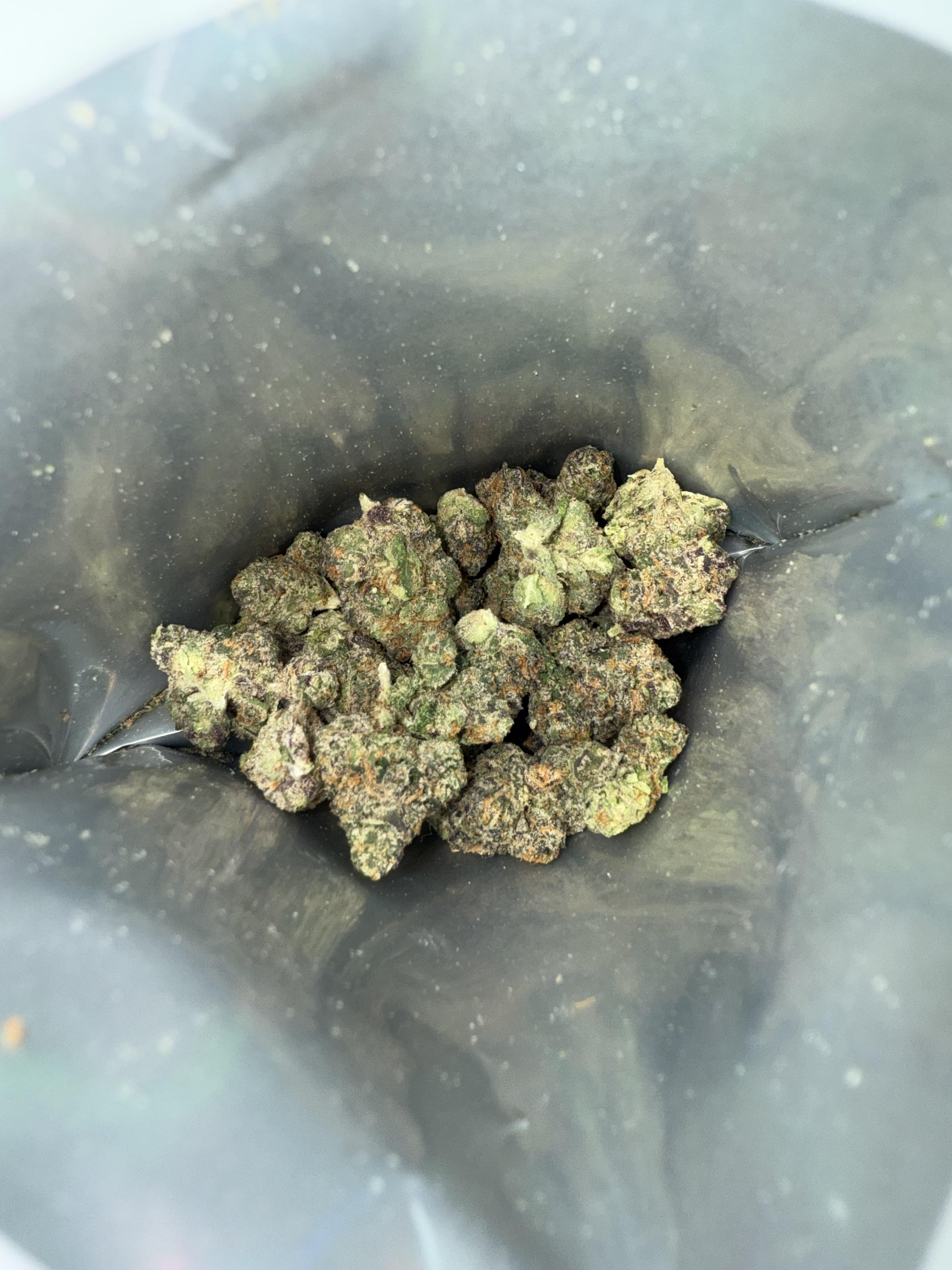 Crane Kick cannabis buds with heavy trichomes and high THC content, sativa-dominant hybrid strain