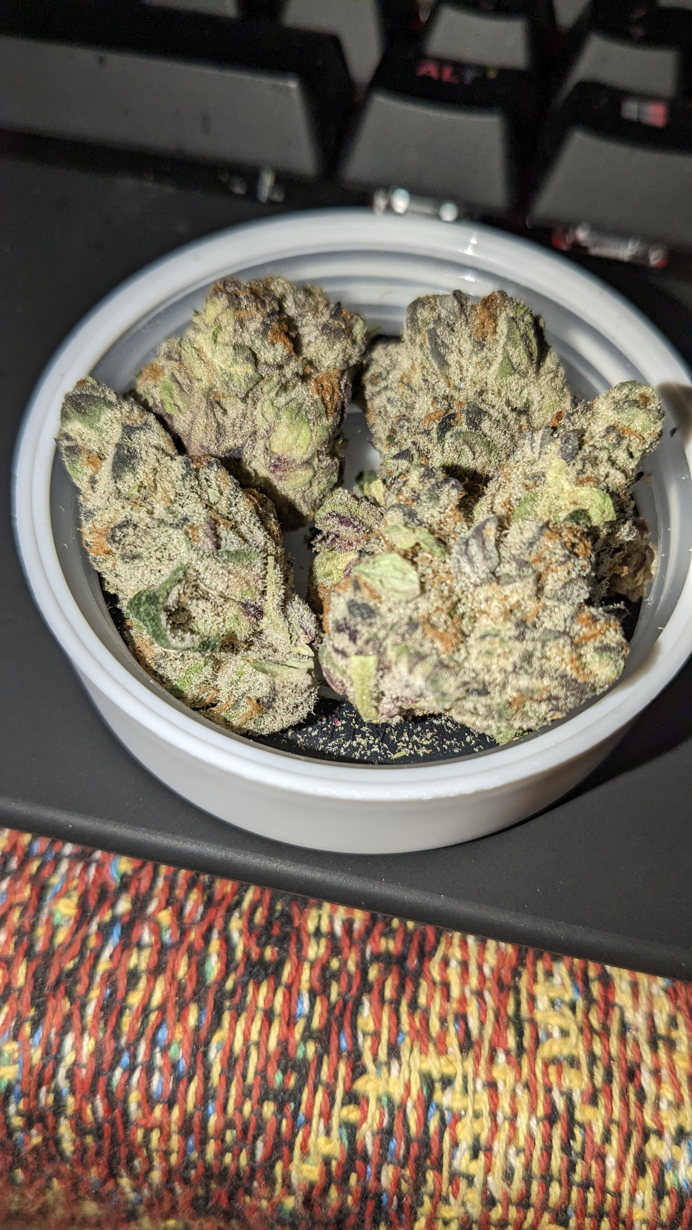 Royal Persica cannabis strain with purple buds and frosty trichomes showing THC 28.6%