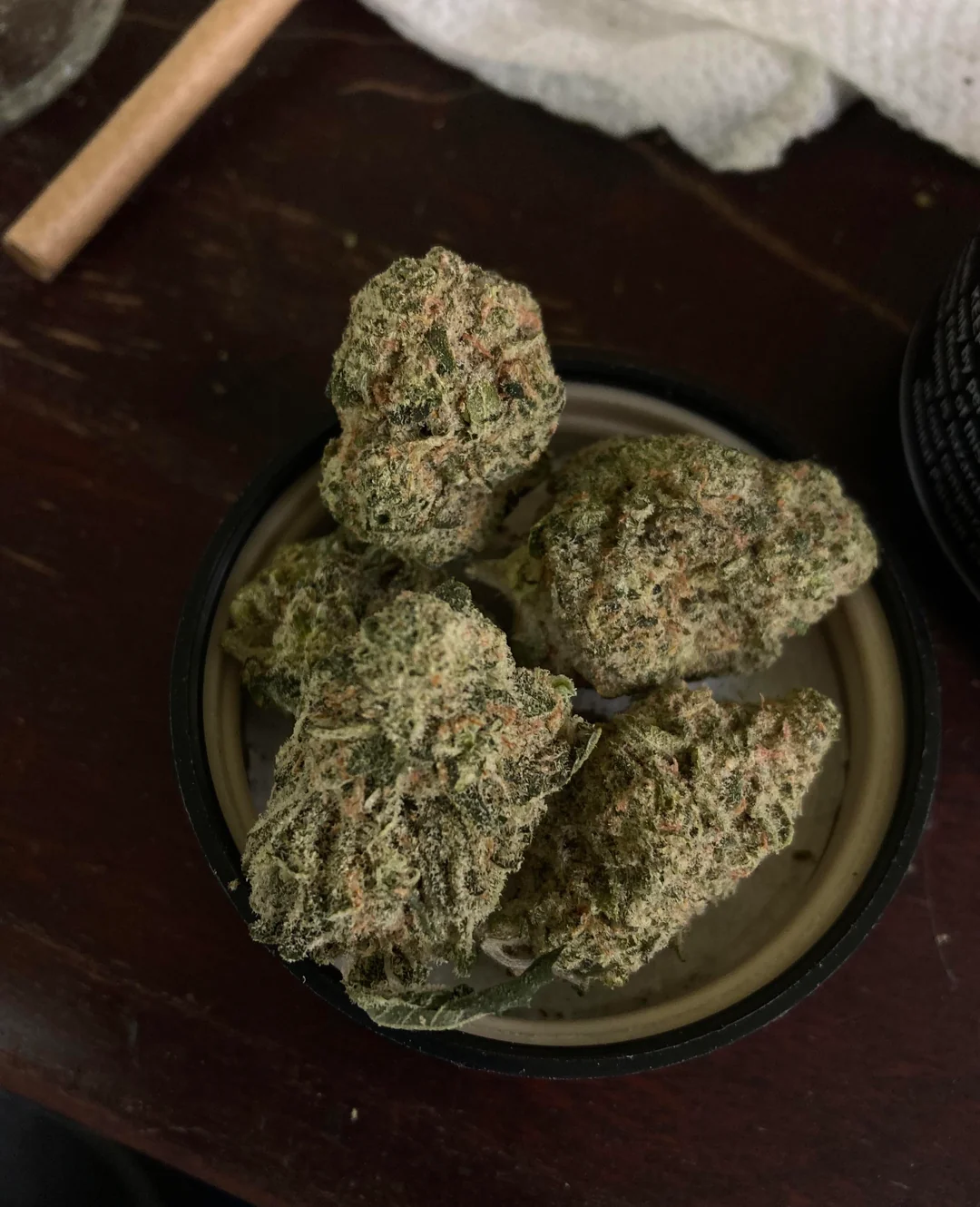 Sour Splash cannabis strain buds showing frosty trichomes and ~22% THC in a modern urban display