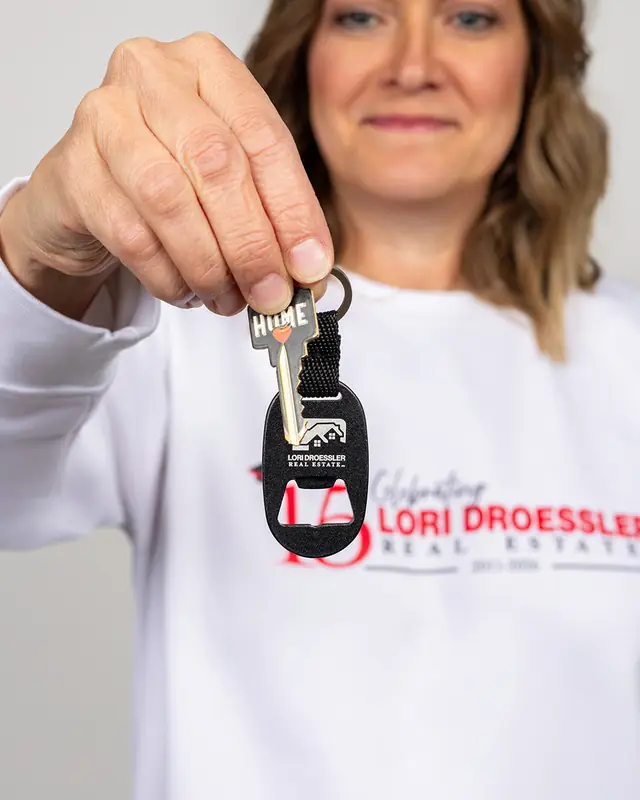 Heather McNeill holding out a house key