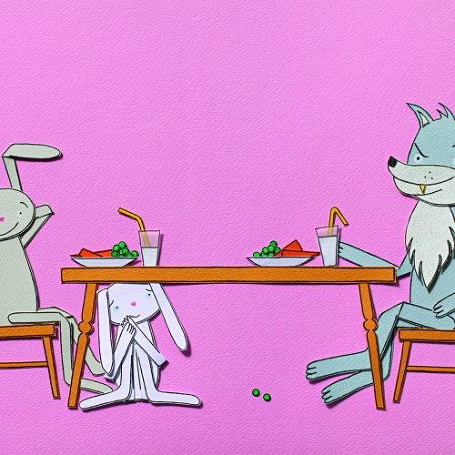 Paper cutouts of rabbits and a wolf sit at a dinner table together
