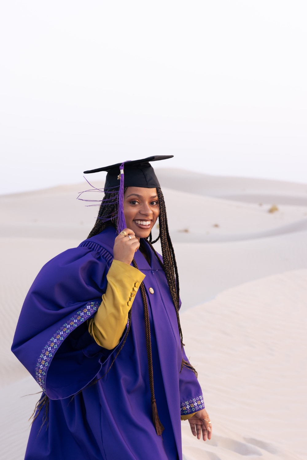 Tatyana in her graduation robe in the sand dunes of Al Wathbah, an area just outside of the metropolitan area of Abu Dhabi