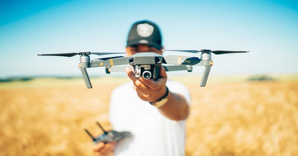 man holding drone in field