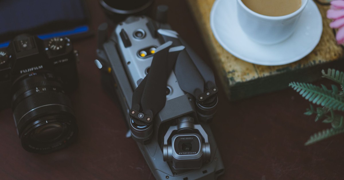 drone and camera on a table with coffee