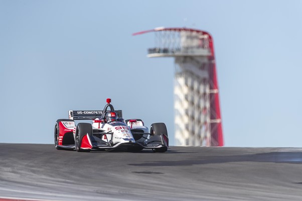 An IndyCar driver takes a practice run on the Circuit of the Americas racing track.