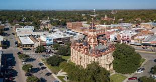 A picture of Lockhart State Park with a lake and trees in the background