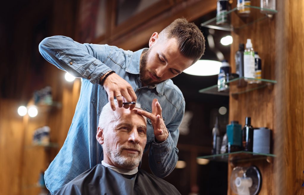 Senior man getting a haircut at the barber
