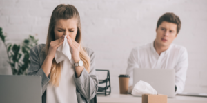 Woman Sneezing From Sick Building Syndrome