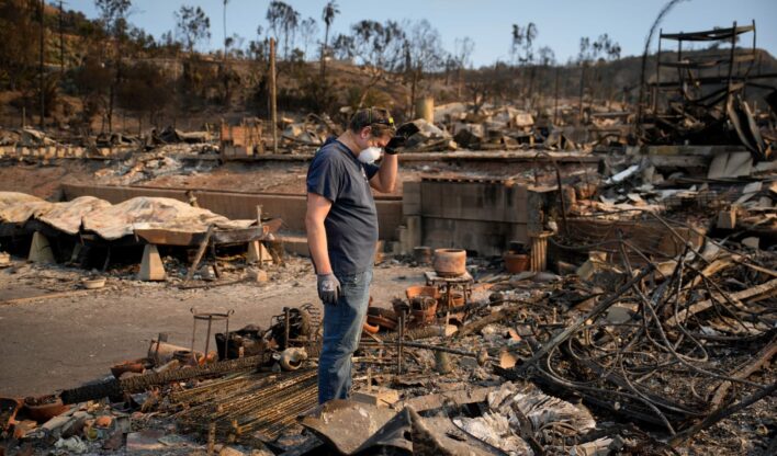 Kevin Marshall vasculha a propriedade de sua mãe devastada pelo incêndio Palisades, no bairro Pacific Palisades, em Los Angeles, neste sábado, 11 de janeiro de 2025.