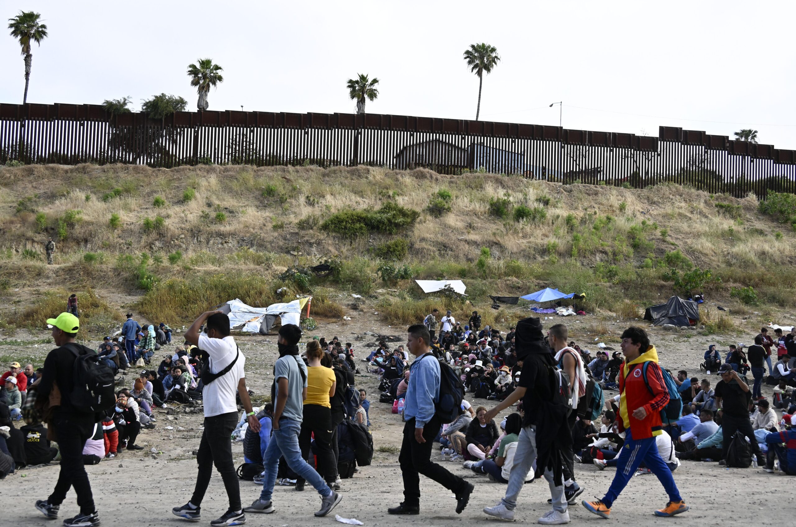 Migrants amass near US-Mexico wall with COVID ban set to end