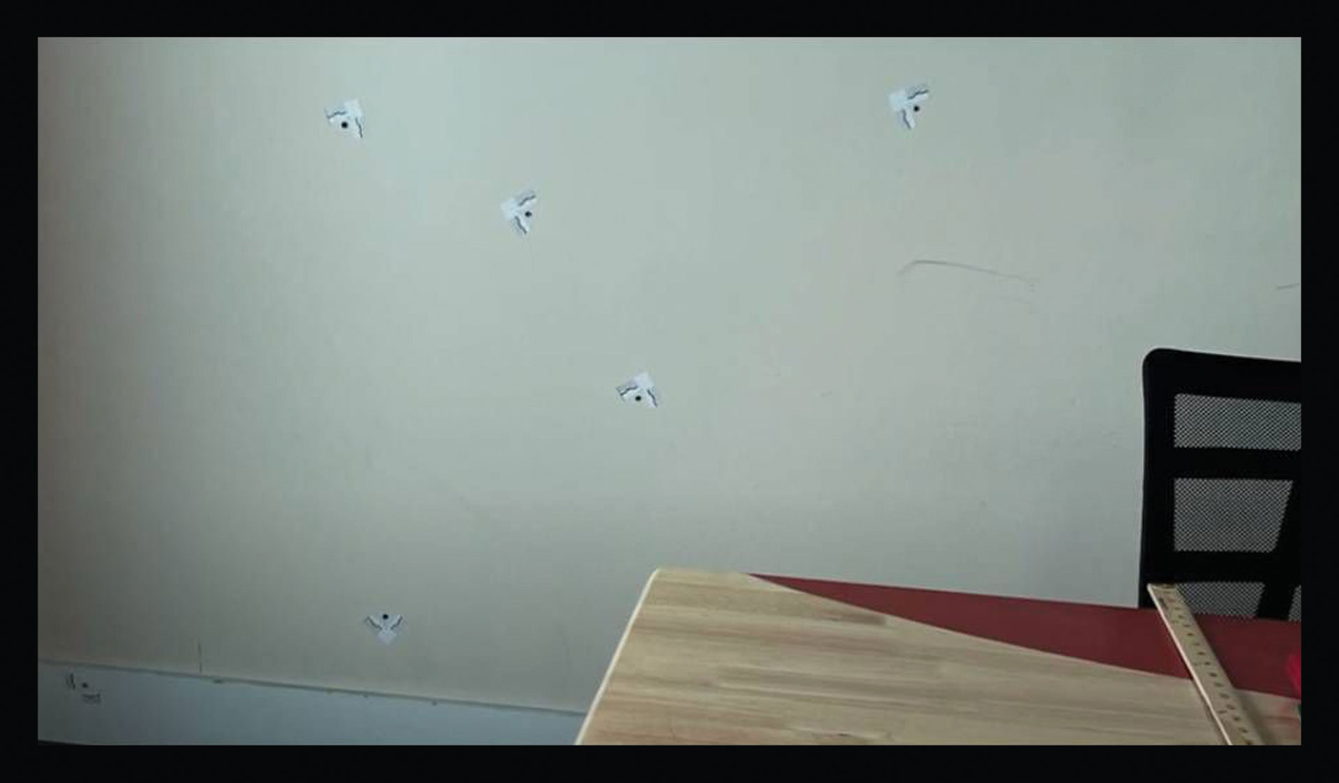 A still from Craig Greenberg's campaign ad showing six bullet holes after an attack on his campaign office on Feb. 14, 2022.