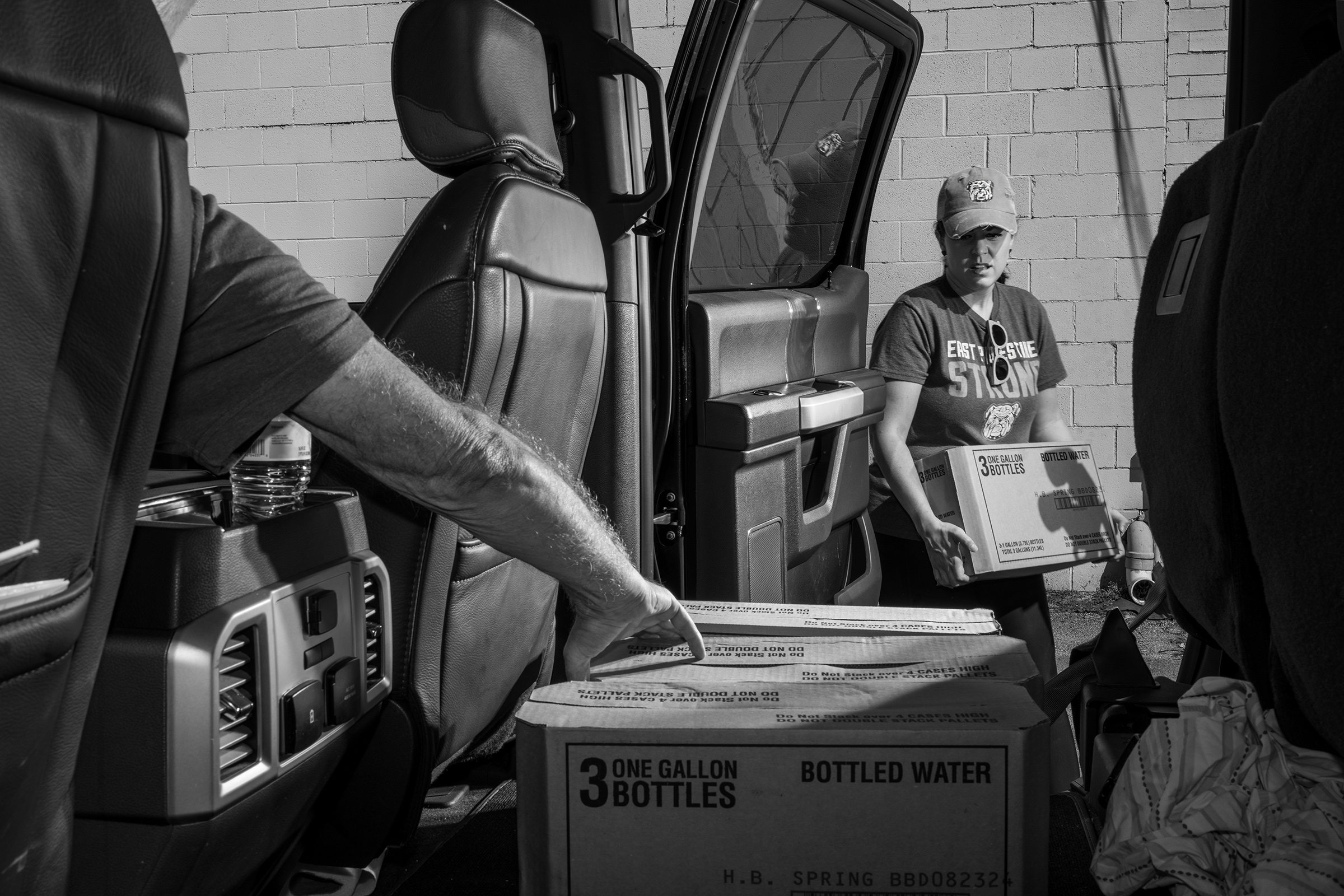 East Palestine resident Misti Allison distributes water on Sept. 17.