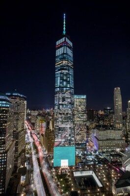 One World Trade Center in New York City illuminated in turquoise.