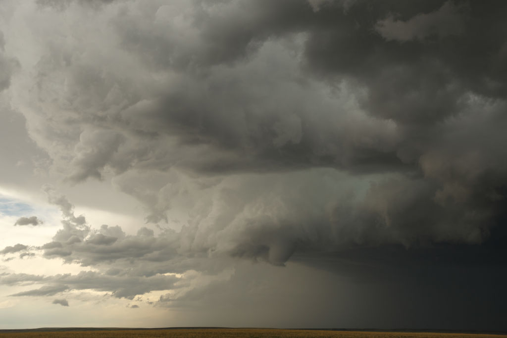 A small funnel cloud forms in the distance during a supercell thunderstorm, May 8, 2017 in Elbert County, Colorado. 
