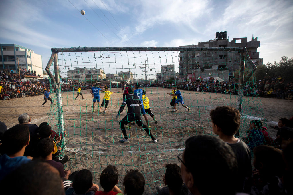 Palestinian youths play football during the holy month of