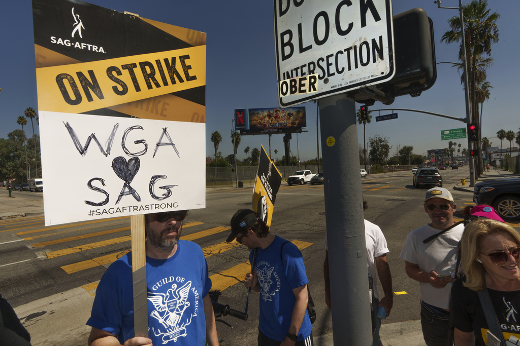 SAG-AFTRA actors walk on a picket line outside Netflix studios on Tuesday, Sep. 26, 2023, in Los Angeles.