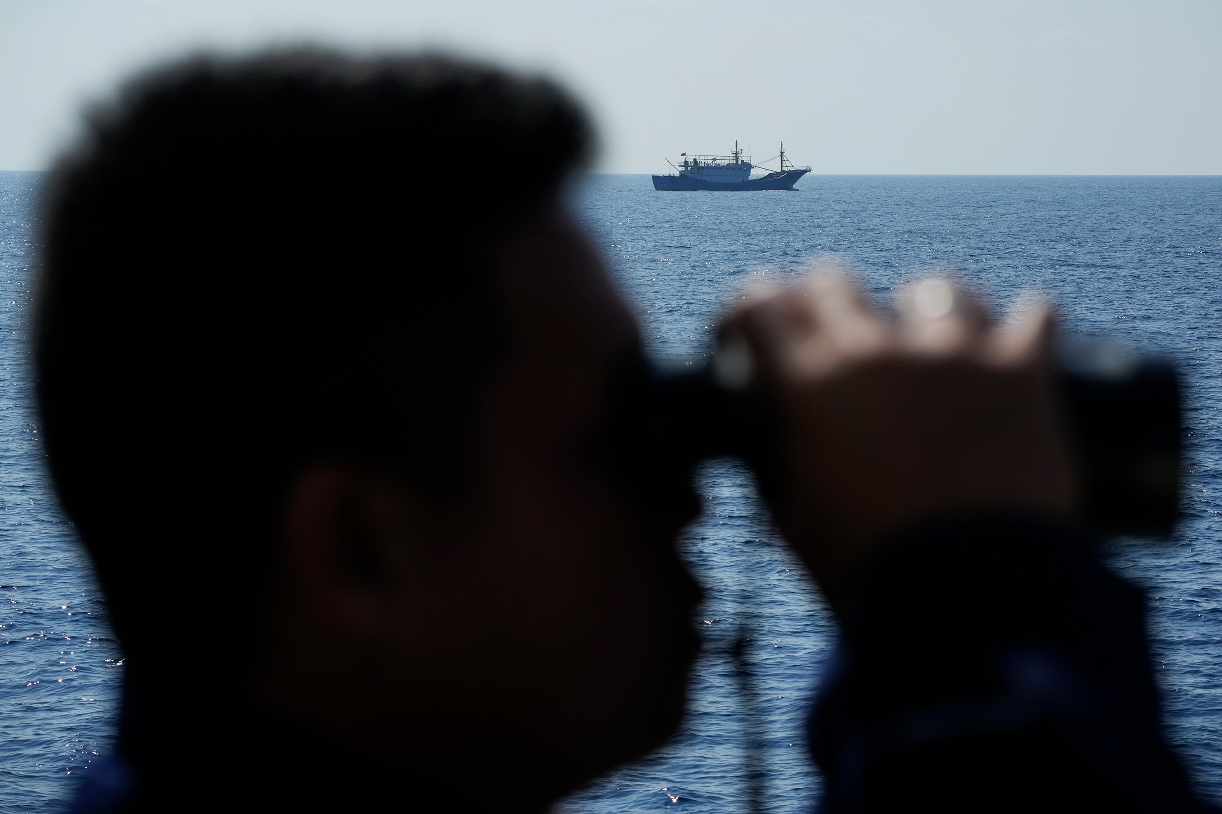 Isang pinaghihinalaang Chinese militia ship na dumadaan habang ang mga kasapi sa Philippine Coast Guard BRP Malabrigo ay pinalalayas sila mula sa mga lugar na kinokontrol ng Pilipinas sa South China Sea noong Abril 21.