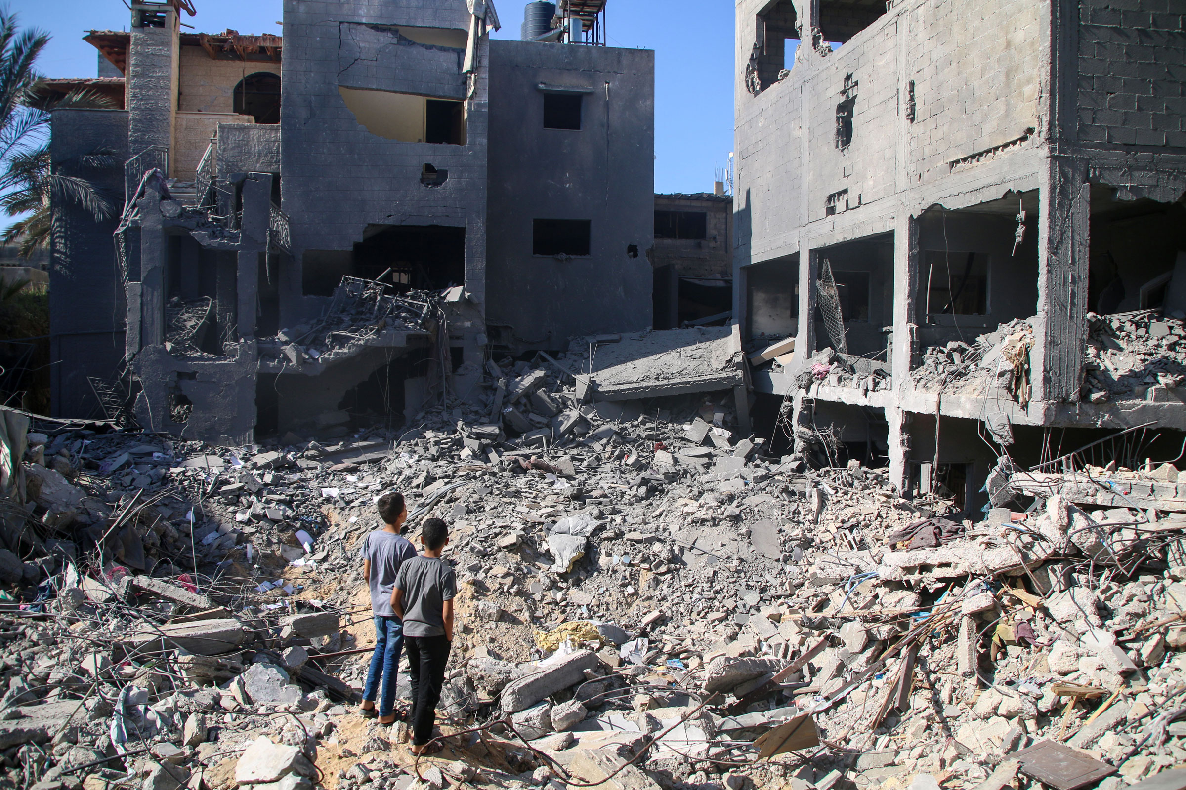 Local citizens search for victims in buildings destroyed during Israeli air raids