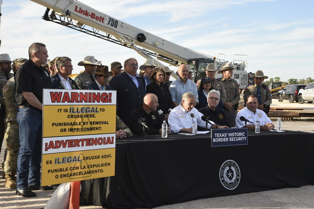 Gov. Greg Abbott signs three bills into law at a border wall construction site in Brownsville, Texas on Monday, Dec. 18, 2023, that will broaden his border security plans and add funding for more infrastructure to deter illegal immigration.