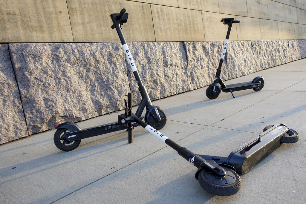 Sharable electric scooters by Bird Rides, Inc. wait on downtown sidewalks for pedestrian use, Oct. 2, 2019, in downtown Cincinnati.