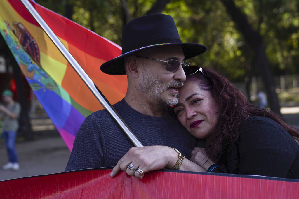 Adolfo Voorduin, left, and Nancy Martinez embrace during a rally by members of the LGBTQ+ community to protest the murder of transgender activist Samantha Gomes Fonseca in Mexico City, Monday, Jan. 15, 2024. Gomes was shot in Mexico City Sunday.