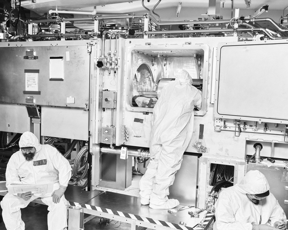 An Optics Processing technician prepares a Grating Debris Shield  for inspection in the Optical Processing Facility at Lawrence Livermore National Laboratory in Livermore, California, United States on December 8, 2023.