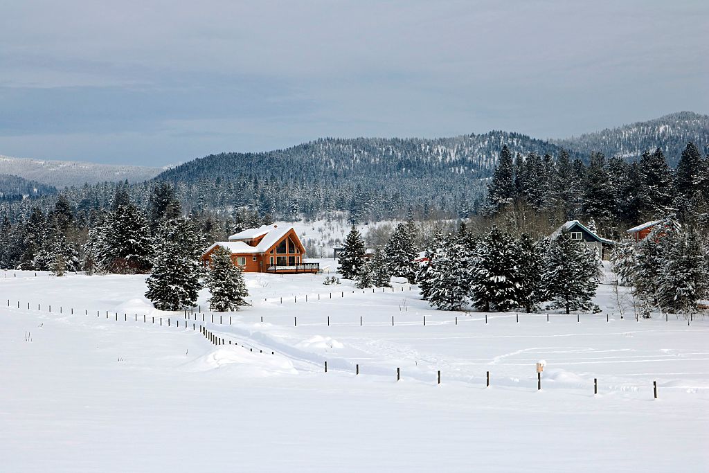 A-frame rural home in mountain valley in winter