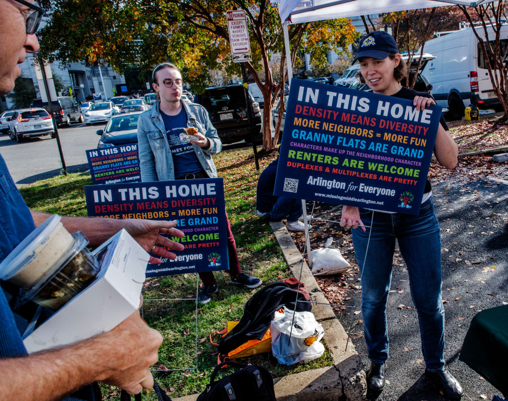 Arlington citizens at a county board meeting with their signs demanding more affordable houseing, on November 12 in Arlington, VA.