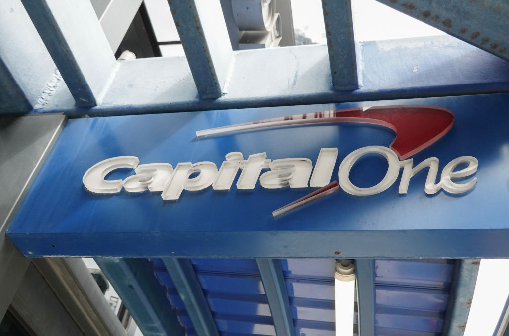 A sign hangs above an entranceway to a Capital One Café on Feb. 19, 2024, in Miami, Fla.