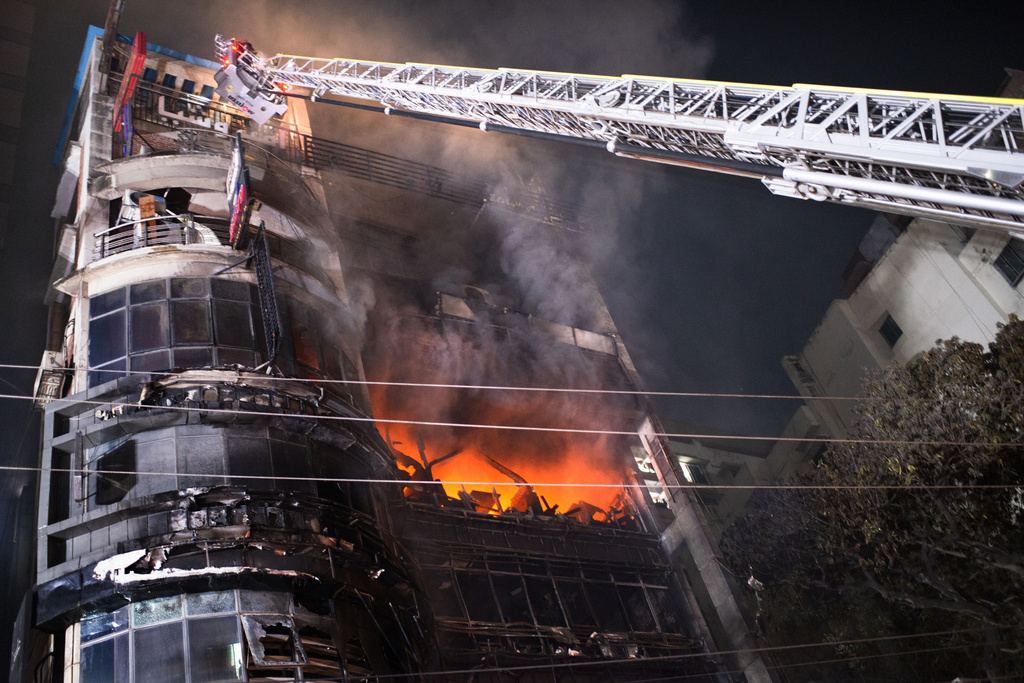 Firefighters work to contain a fire that broke out at a commercial complex in Dhaka, Bangladesh, Thursday, Feb. 29, 2024.