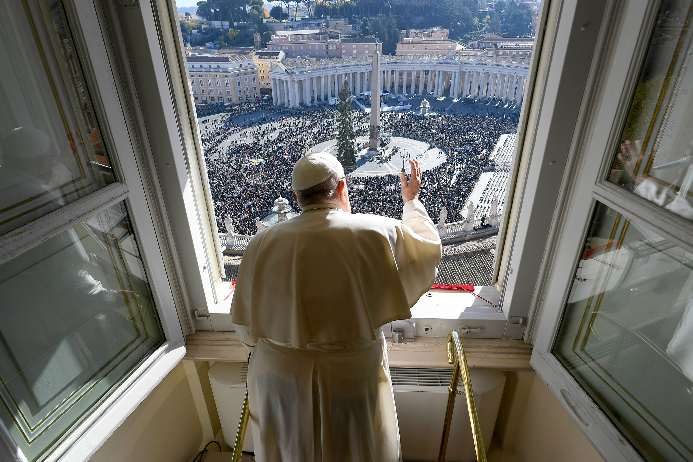 Pope Francis waves to the crowd gathered in St. Peter's Square during his Sunday Angelus blessing on Nov. 24, 2024.
