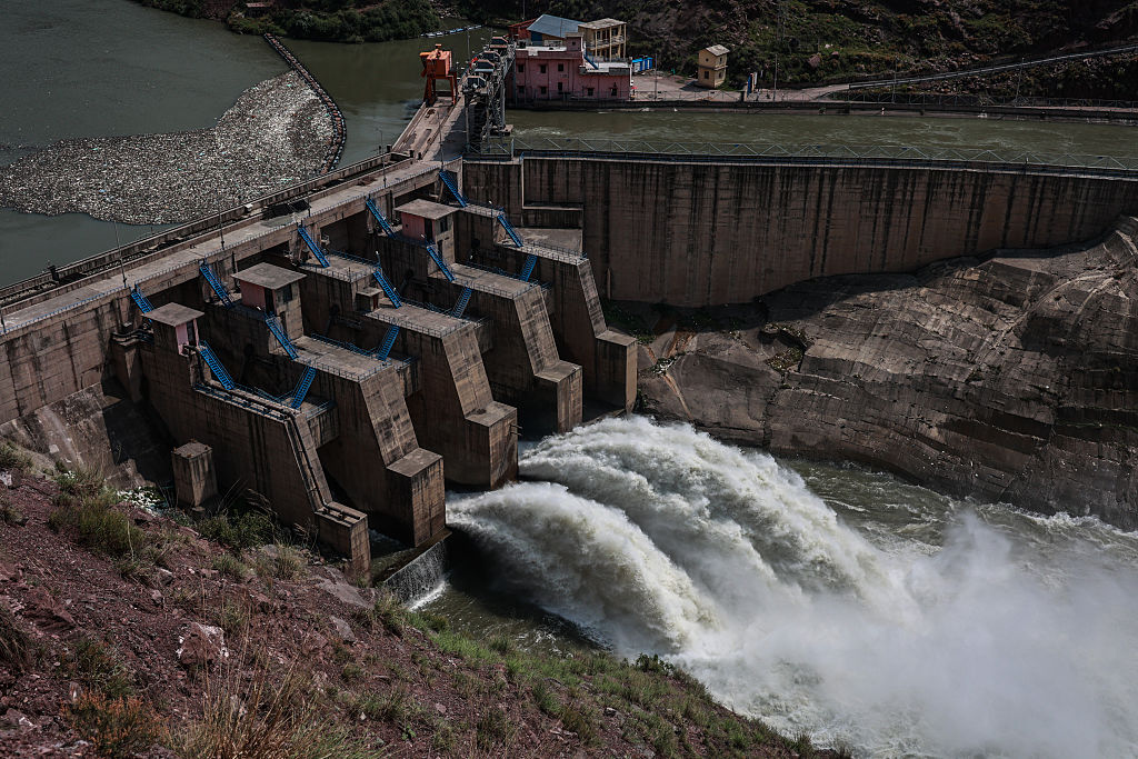 Water flows from the Lower Jhelum Hydel Project Dam over the Jhelum River in Baramulla, Jammu and Kashmir, India, on May 6, 2025.