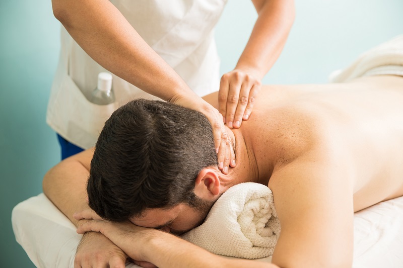 closeup young man getting neck massage therapy spa clinic