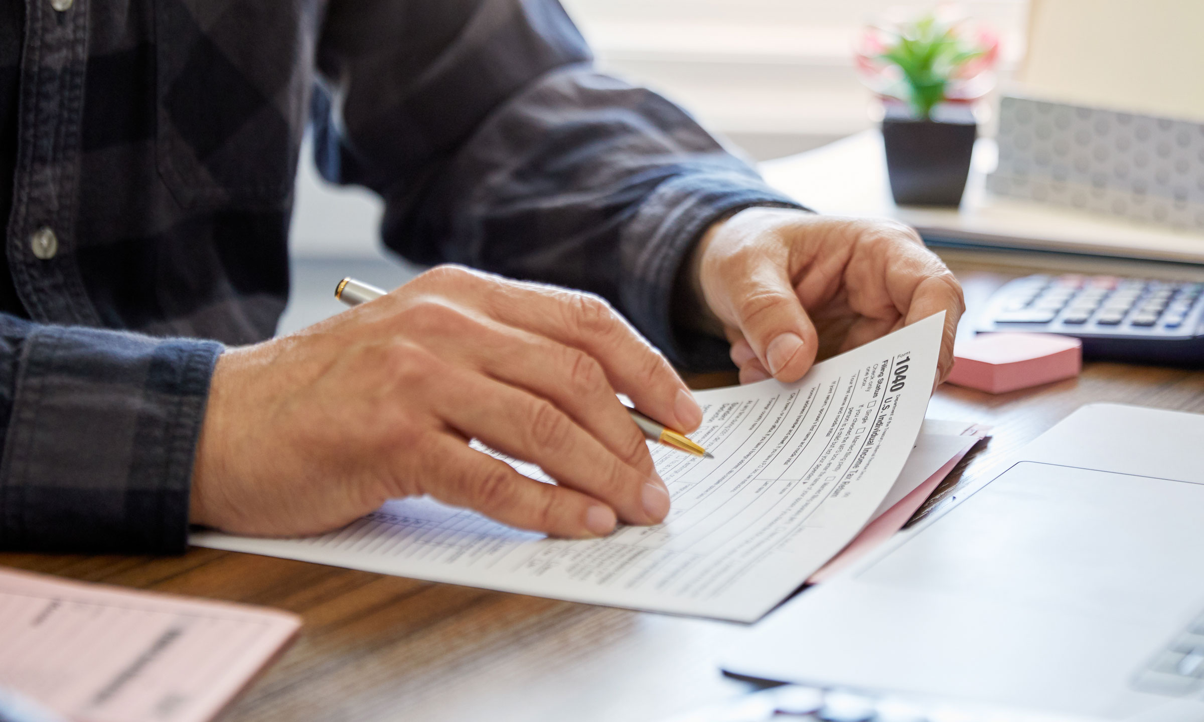 Close-up of a man holding a tax form