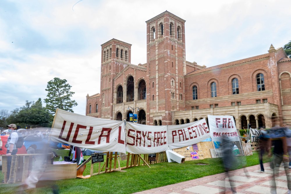 Pro-Palestine supporters link arms on Janss Steps at UCLA while facing police officers in the early hours of May 2. The Palestine solidarity encampment was attacked by counterprotesters the day before. 