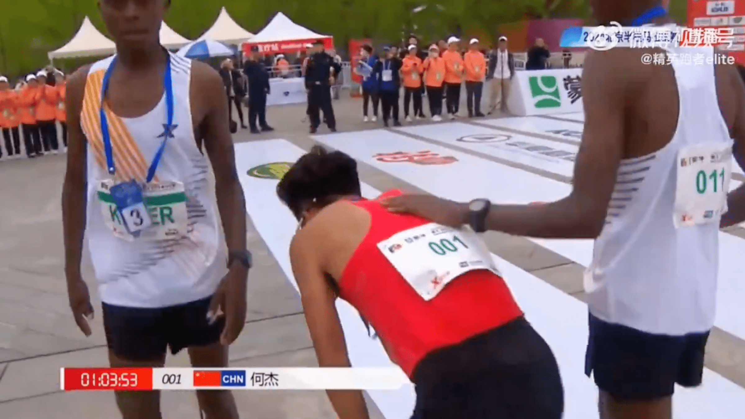 A screenshot from Teacher Li’s Twitter account (@whyyoutouzhele) shows Chinese marathoner He Jie patted on the back by his fellow runners after finishing first at the Beijing half-marathon Sunday, April 14. He’s victory has been the subject of controversy after his fellow runners are accused of slowing down to let him lead.