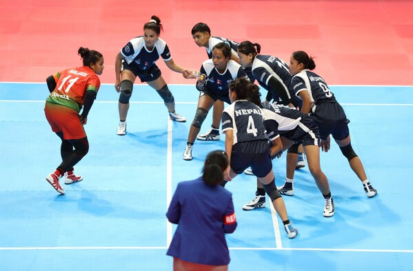 Photo shows a women's kabaddi game between Nepal and Bangladesh at the 19th Asian Games in Hangzhou, east China's Zhejiang province, Oct. 2, 2023. (Photo by Han Xiaoming/People's Daily)