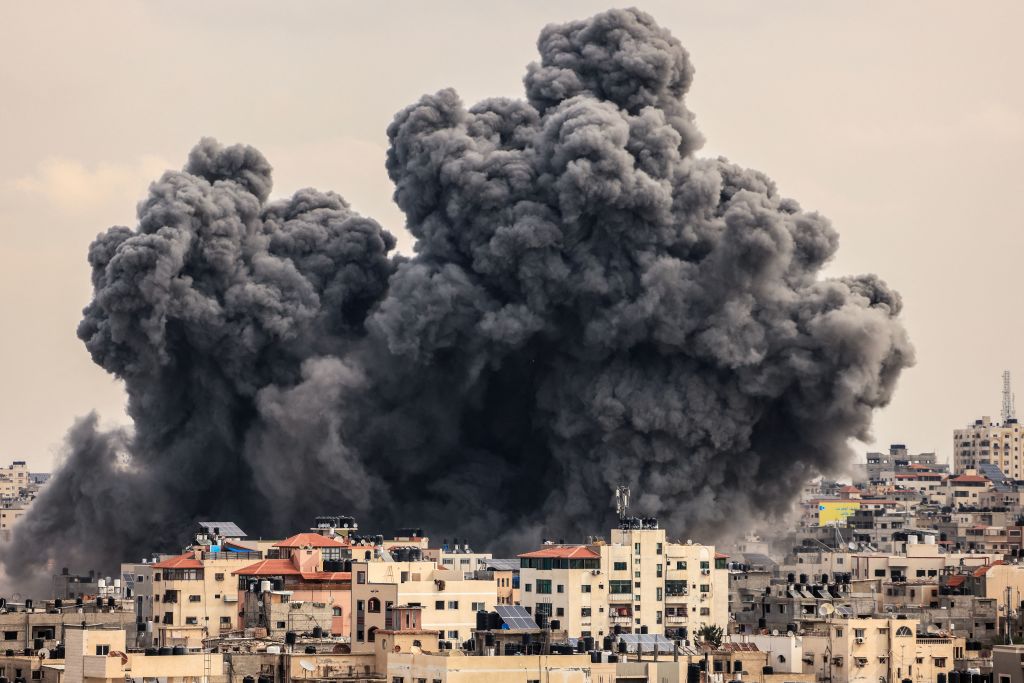 A plume of smoke rises in the sky of Gaza City during an Israeli airstrike on Oct. 9, 2023. 