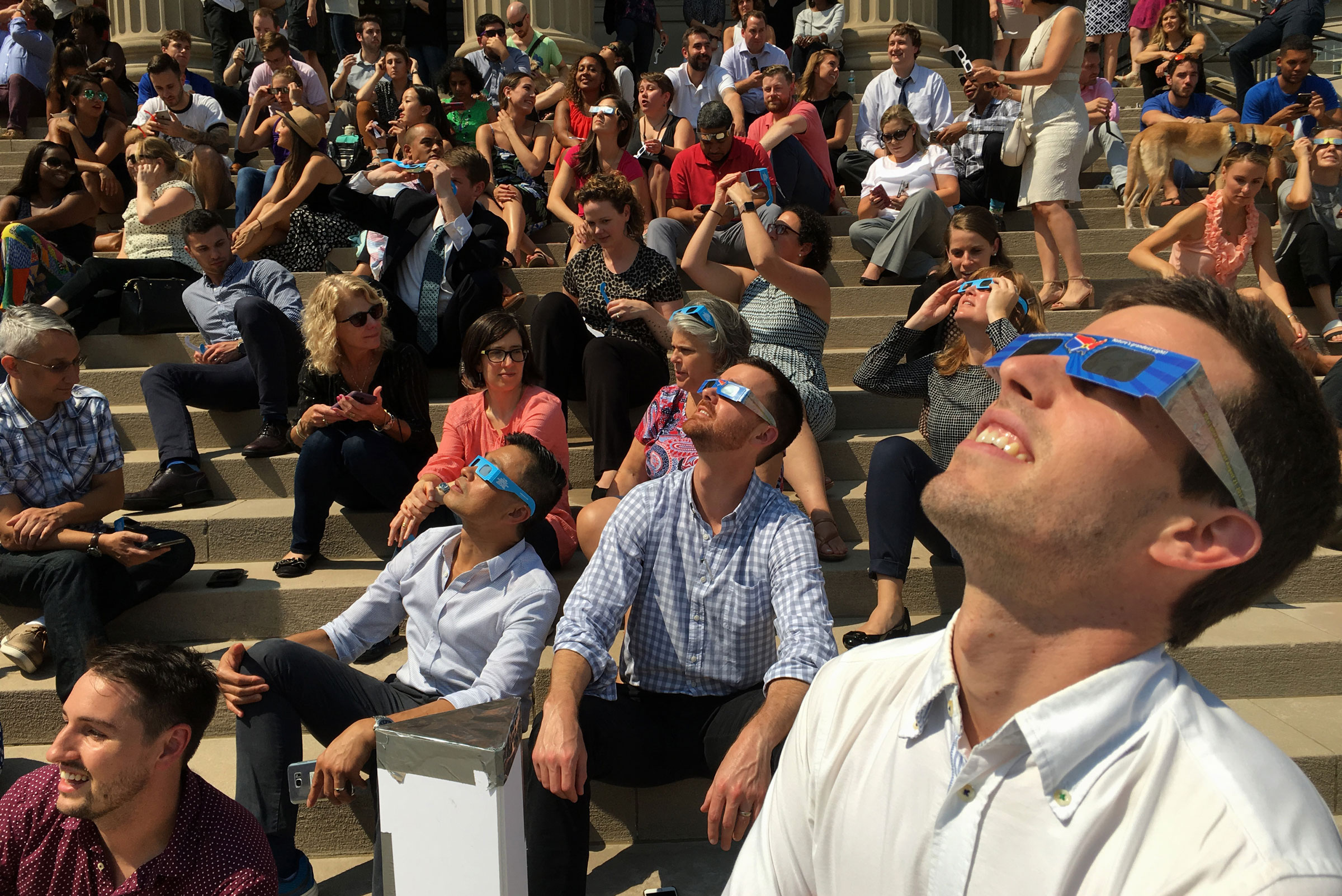 A crowd watches the eclipse from the steps of National City Christian Church in Washiington, D.C., on Aug. 21, 2017.