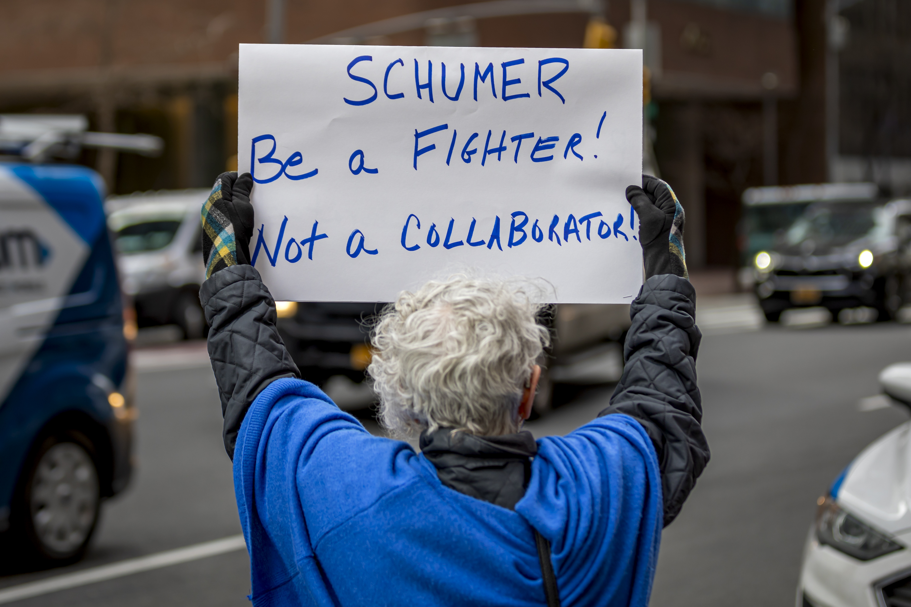 An activist participates in a protest outside the office of